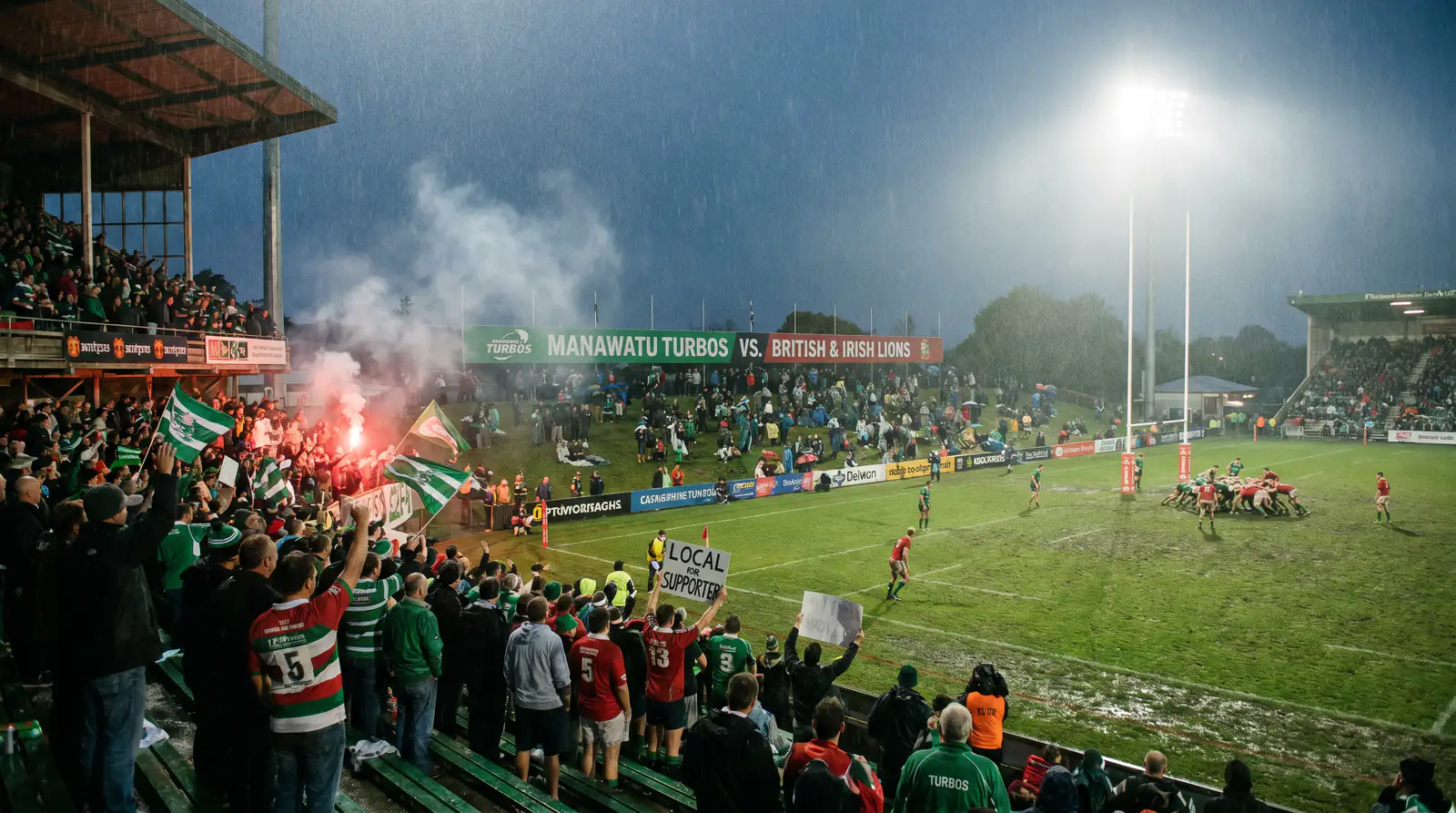 Smaller provincial stadium hosting a Lions midweek tour match with local supporters
