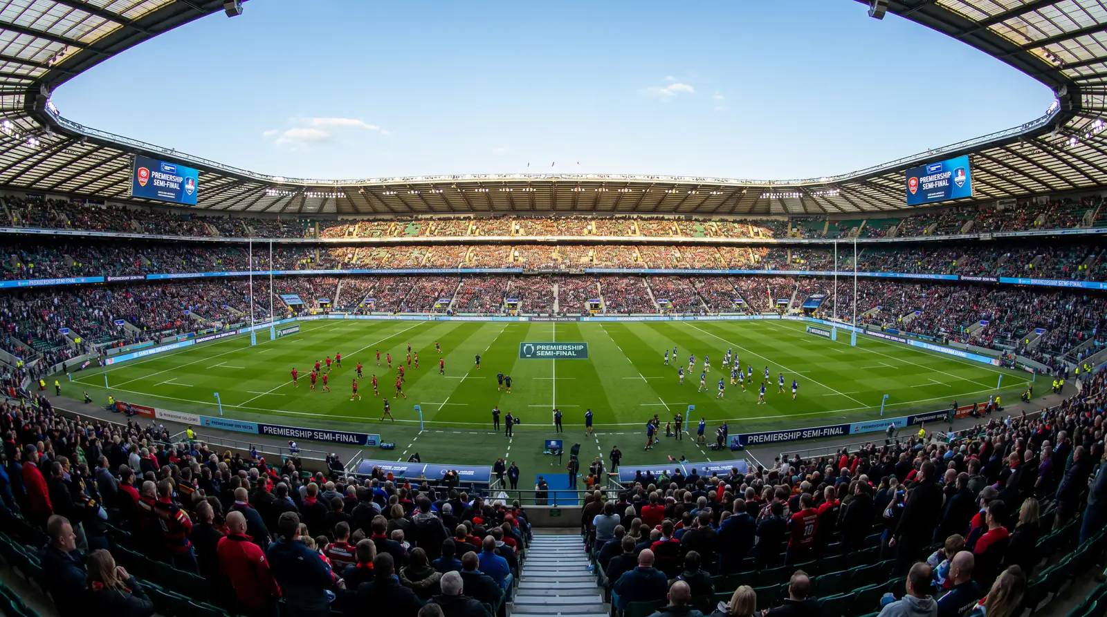 Rugby stadium on semi-final day with teams warming up on the pitch