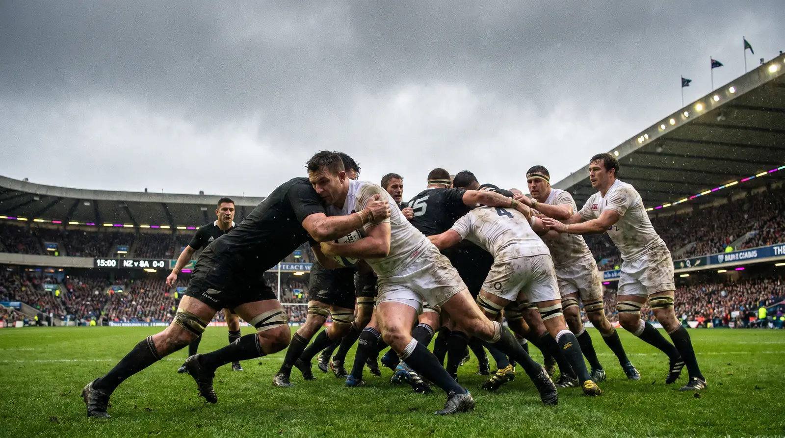 Two rugby teams locked in a tight defensive contest during the first half