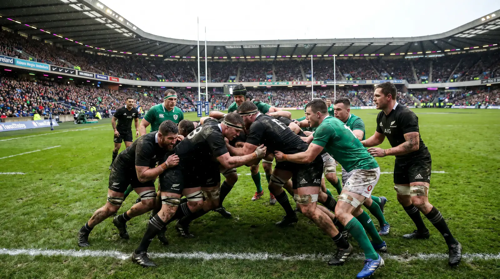 Rugby forwards driving a maul towards the try line near the opposition posts