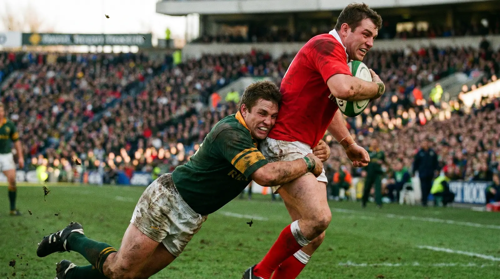 Rugby player making a textbook low tackle illustrating defensive technique