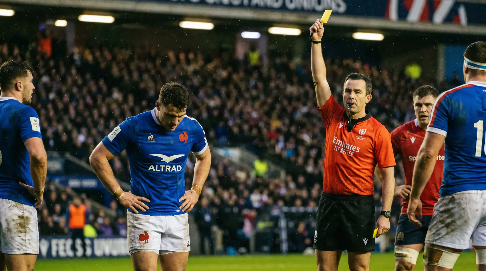 Rugby referee showing a yellow card to a player during a professional match