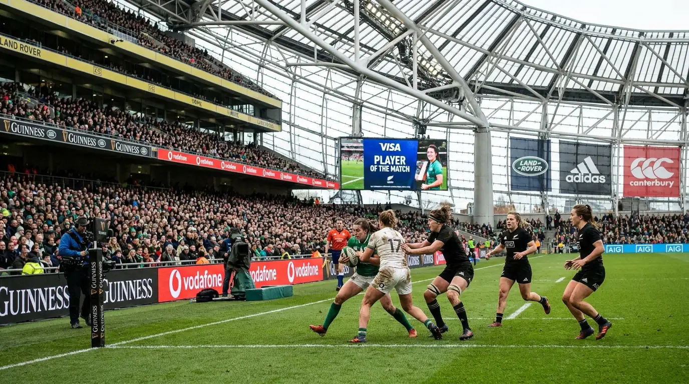 Women's rugby match with visible commercial branding and sponsor signage at the venue